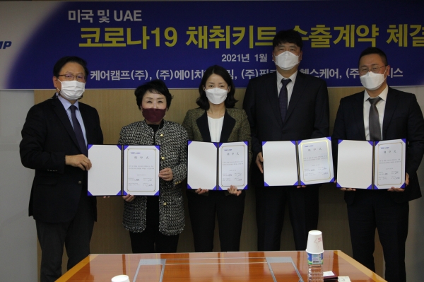 유광렬(왼쪽) 대표와 조선혜(왼쪽에서 두번째) 케어캠프 대표 등 관계자들이 코로나19 검체채취키트 수출계약을 체결한 뒤 기념사진 촬영을 하고 있다.