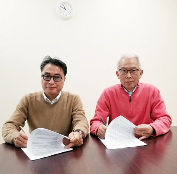 고 김정근 대표(왼쪽)와 고종성 대표가 J&J/유한양행과 기술수출 계약서에 서명하고 포즈를 잡았다. 사진= 필자 제공.